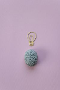 A brain with a lightbulb above it to show a good idea.