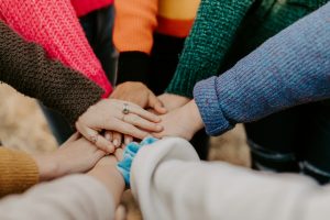 People putting their hands together as a group.