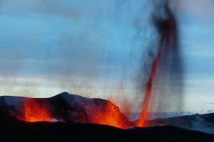 A sudden explosion from a volcano.