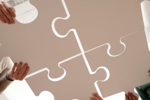 Puzzle pieces being aligned and connected.