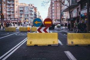 A blocked road with a detour sign.