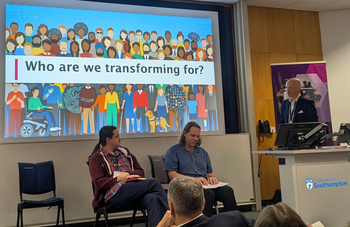 Matthew Deeprose, Dr Ben Whitburn and Joshie Christian presenting at the event. Their presentation slide says 'Who are we transforming for?'