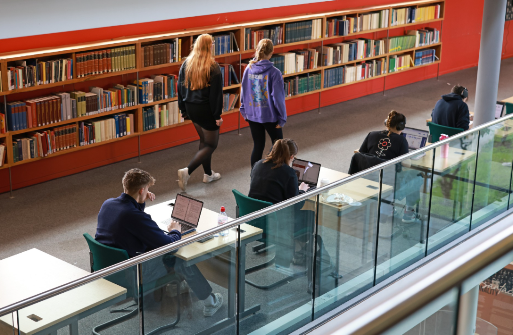 Students working in a library space